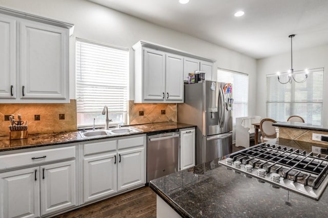 3301 Ski Lift Ct, Mckinney, TX 75070 - kitchen featuring a sink, stainless steel appliances, a notable chandelier, plenty of natural light, and decorative backsplash
