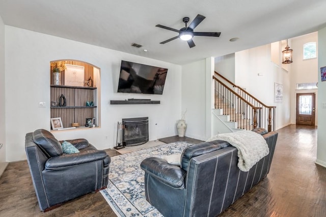 3301 Ski Lift Ct, Mckinney, TX 75070 - living area featuring stairs, visible vents, dark wood finished floors, a ceiling fan, and a fireplace with flush hearth