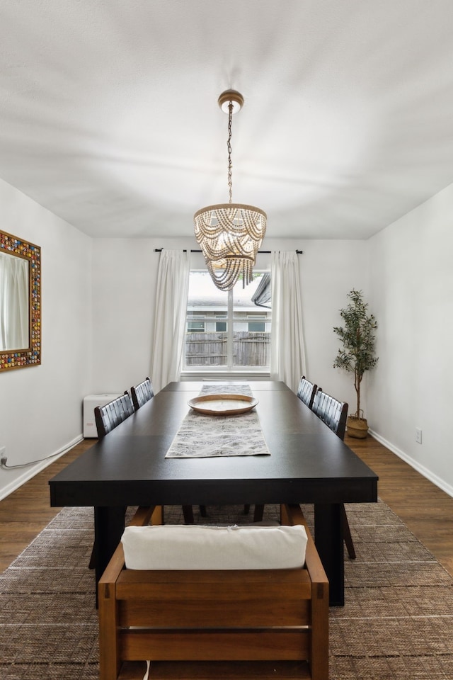 3049 Rotan Ln, Dallas, TX 75229 - dining area with an inviting chandelier, baseboards, and wood finished floors