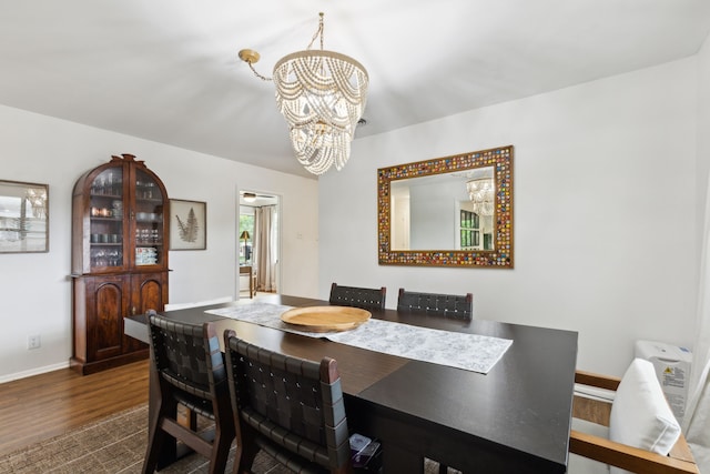 3049 Rotan Ln, Dallas, TX 75229 - dining room featuring baseboards, a chandelier, and dark wood-type flooring
