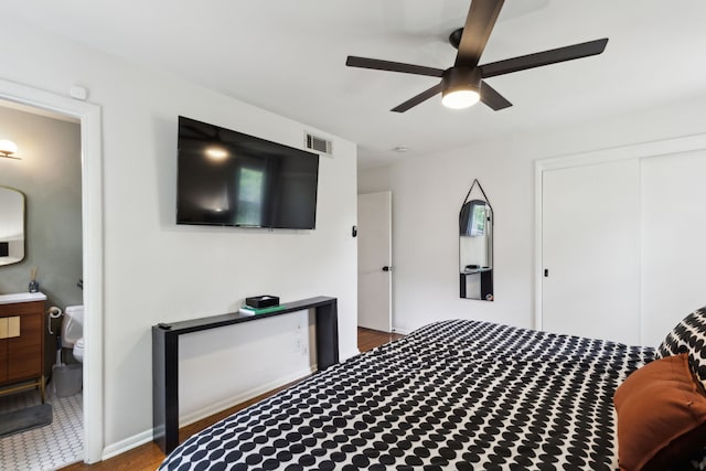 3049 Rotan Ln, Dallas, TX 75229 - bedroom featuring ceiling fan, visible vents, wood finished floors, a closet, and ensuite bathroom