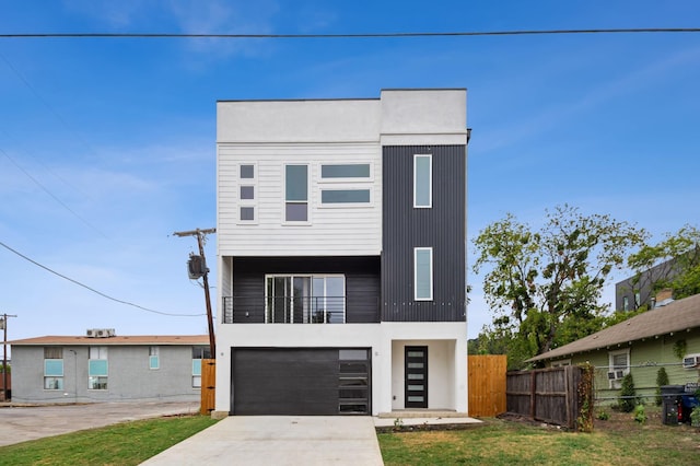 1922 Annex Ave, Dallas, TX 75204 - contemporary home with fence, stucco siding, an attached garage, and driveway