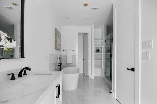 1922 Annex Ave, Dallas, TX 75204 - bathroom with visible vents, a soaking tub, marble finish floor, and vanity