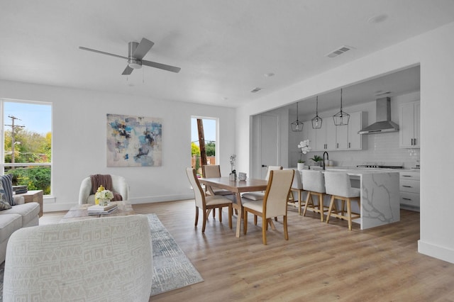 1922 Annex Ave, Dallas, TX 75204 - dining room featuring light wood-style floors, baseboards, ceiling fan, and visible vents
