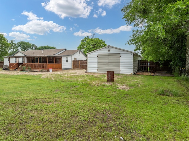 back of property featuring a lawn, a fenced backyard, and a garage