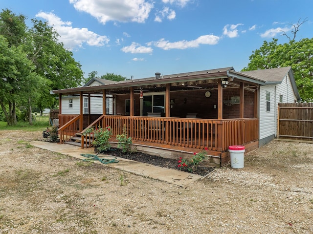 rear view of property featuring fence