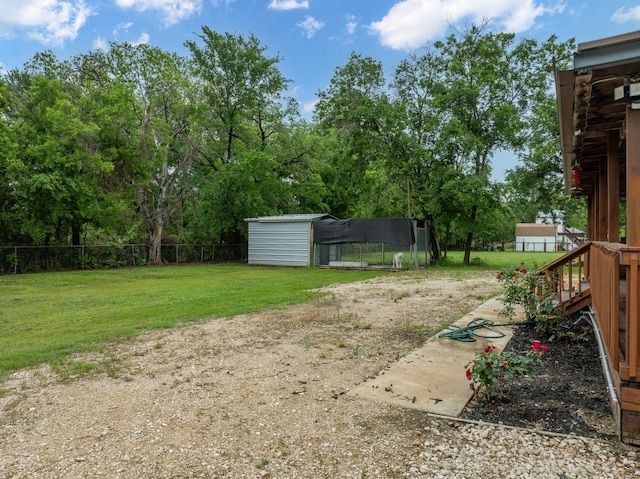 view of yard featuring fence and an outdoor structure