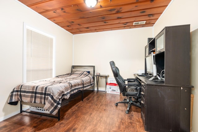 bedroom with wood ceiling, baseboards, wood finished floors, and visible vents