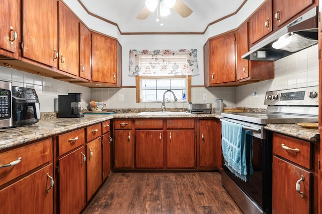 kitchen featuring a sink, stainless steel appliances, backsplash, under cabinet range hood, and dark wood-style floors