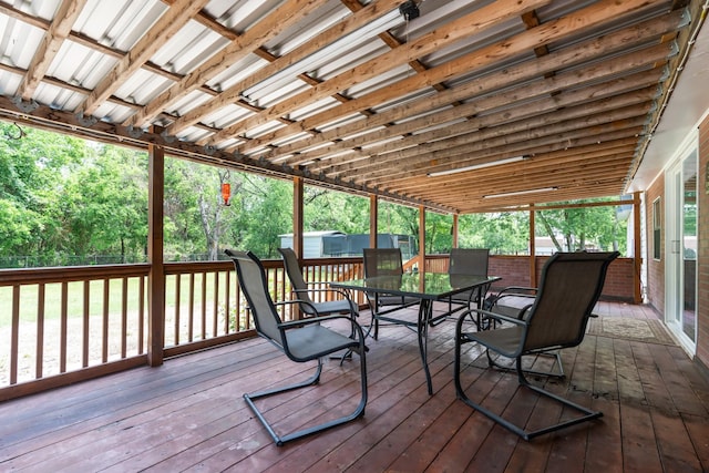 sunroom featuring outdoor dining area