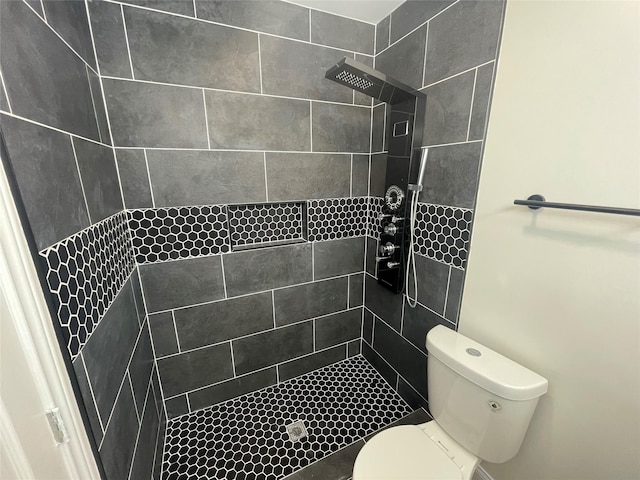 full bath featuring toilet and tiled shower