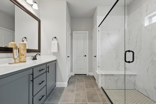 9208 Amistad Ln, Denton, TX 76226 - bathroom with a sink, double vanity, a marble finish shower, and baseboards
