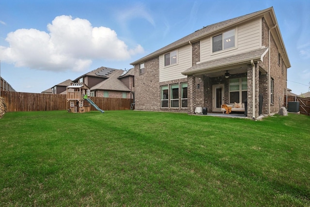 9208 Amistad Ln, Denton, TX 76226 - rear view of property with a yard, a ceiling fan, a fenced backyard, and a playground