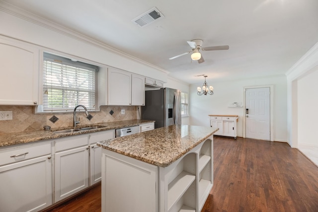 kitchen featuring visible vents, open shelves, tasteful backsplash, a sink, and stainless steel appliances