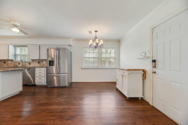 kitchen featuring ornamental molding, ceiling fan with notable chandelier, dark wood-style floors, white cabinetry, and appliances with stainless steel finishes