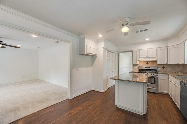 kitchen featuring visible vents, a kitchen island, a ceiling fan, stone counters, and appliances with stainless steel finishes