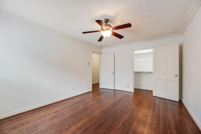 unfurnished bedroom featuring crown molding, baseboards, a closet, and dark wood-style flooring
