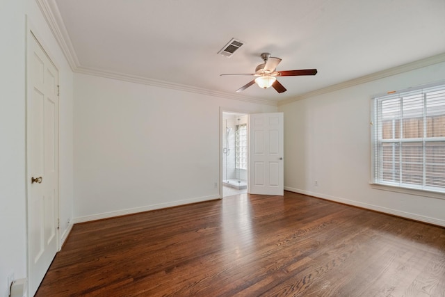 spare room featuring crown molding, a ceiling fan, wood finished floors, and visible vents
