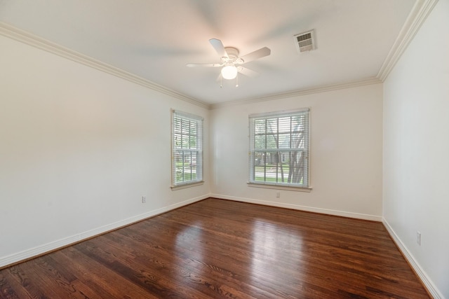 spare room featuring visible vents, a ceiling fan, wood finished floors, and ornamental molding