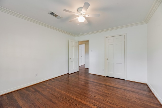 unfurnished bedroom featuring visible vents, ornamental molding, dark wood finished floors, and baseboards