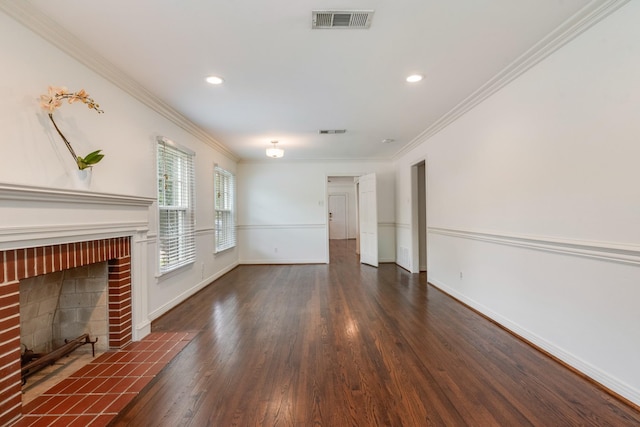 unfurnished living room featuring visible vents, ornamental molding, baseboards, and wood finished floors