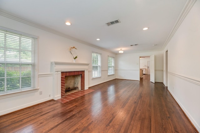 unfurnished living room featuring visible vents, ornamental molding, wood finished floors, and a wealth of natural light