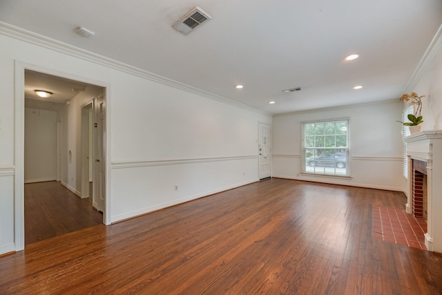 unfurnished living room featuring visible vents, ornamental molding, and wood finished floors