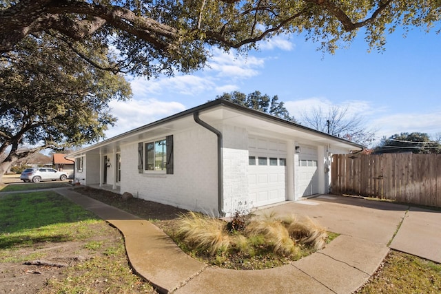 3617 Walton Ave, Fort Worth, TX 76133 - view of side of property featuring fence, a garage, driveway, and brick siding