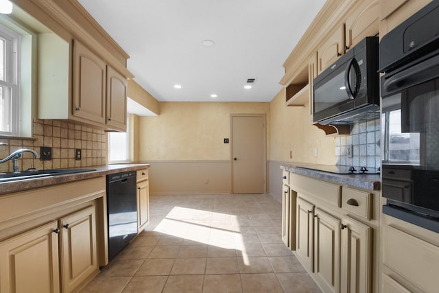 3617 Walton Ave, Fort Worth, TX 76133 - kitchen featuring a sink, backsplash, black appliances, and cream cabinets
