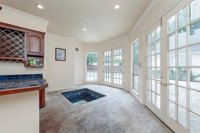 entryway featuring baseboards, ornamental molding, french doors, and recessed lighting
