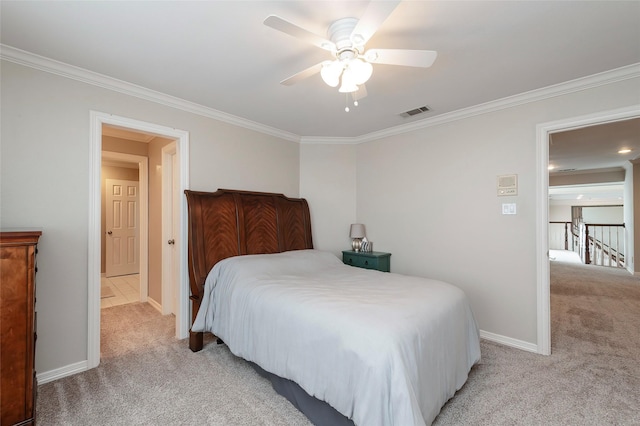 bedroom featuring crown molding, baseboards, visible vents, and light colored carpet
