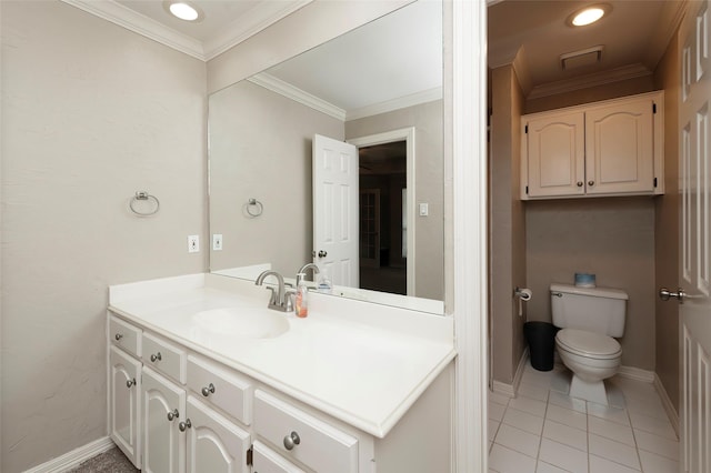 bathroom with toilet, vanity, tile patterned floors, crown molding, and baseboards