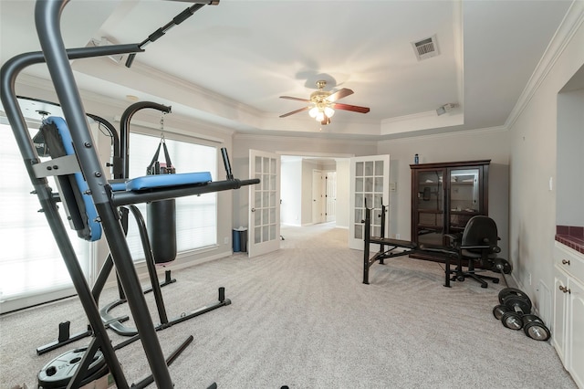 exercise room with french doors, visible vents, crown molding, light carpet, and a raised ceiling