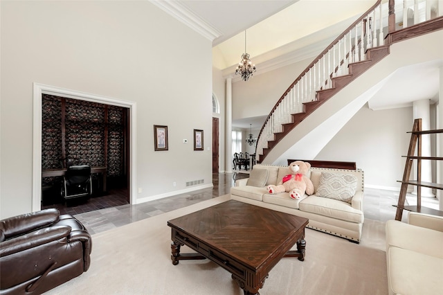 living area with a high ceiling, crown molding, visible vents, baseboards, and stairs