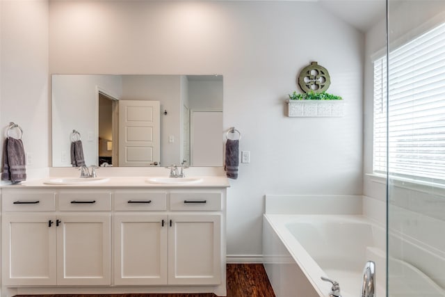 2224 Miramar Dr, Little Elm, TX 75068 - bathroom with double vanity, a sink, and a bath