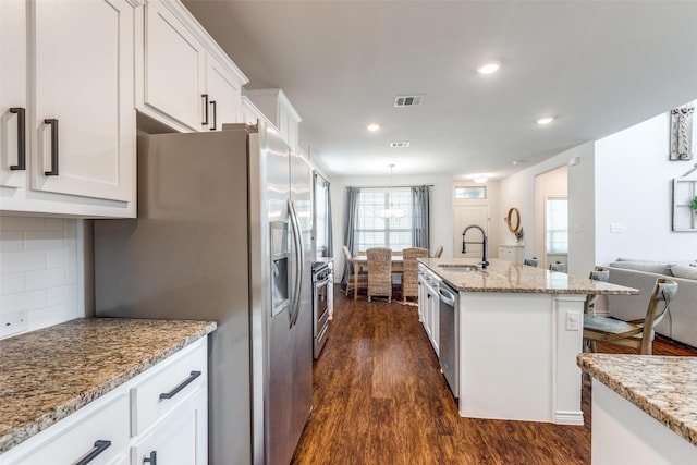 2224 Miramar Dr, Little Elm, TX 75068 - kitchen with visible vents, dark wood-type flooring, white cabinetry, a sink, and stainless steel appliances