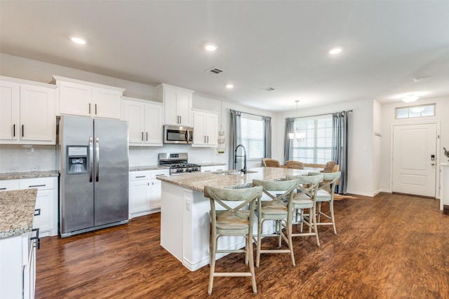 2224 Miramar Dr, Little Elm, TX 75068 - kitchen featuring dark wood-style flooring, stainless steel appliances, a sink, and backsplash