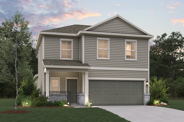 traditional-style home featuring an attached garage, a shingled roof, driveway, and a front yard
