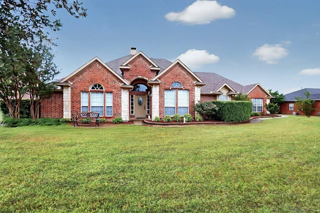 9530 Blarney Stone Way, Forney, TX 75126 - view of front of property featuring brick siding, a front lawn, and a chimney