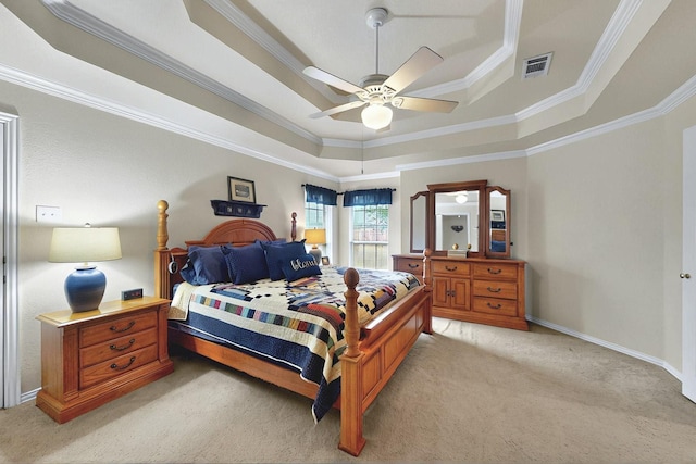 bedroom featuring visible vents, ornamental molding, baseboards, light colored carpet, and a raised ceiling
