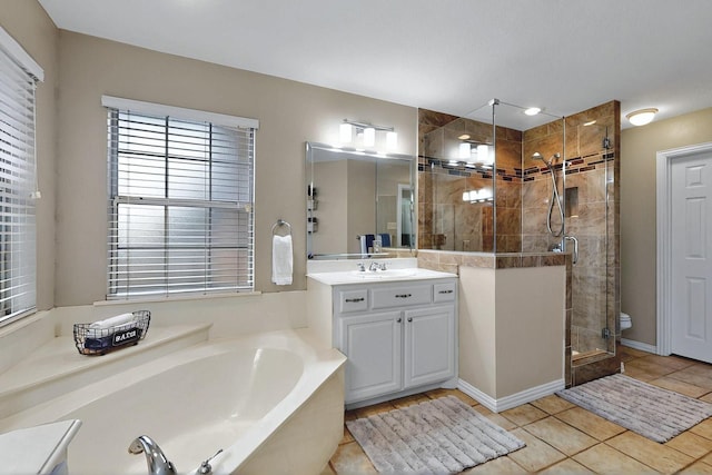 full bath featuring tile patterned flooring, vanity, plenty of natural light, a bath, and a stall shower