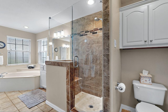 full bath with a garden tub, tile patterned flooring, vanity, toilet, and a stall shower