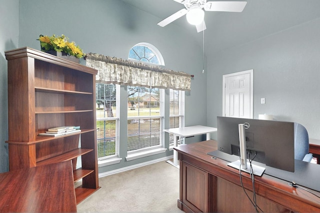 office with ceiling fan, light colored carpet, baseboards, and vaulted ceiling