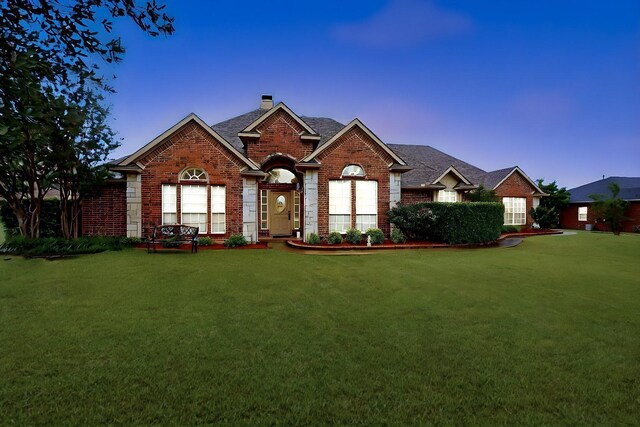 9530 Blarney Stone Way, Forney, TX 75126 - view of front of house featuring brick siding, a front lawn, and a chimney