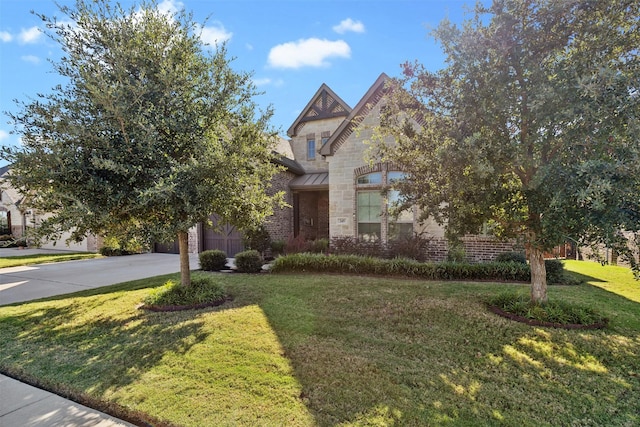 245 Prairie Oak Ct, Burleson, TX 76028 - view of front of property featuring driveway, a front yard, stone siding, a garage, and brick siding