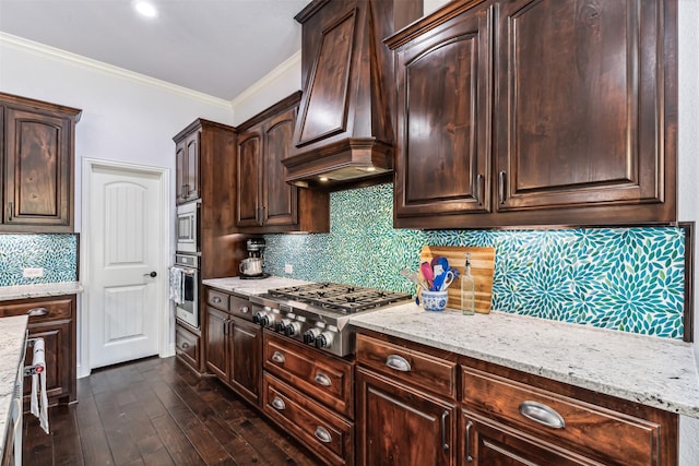 245 Prairie Oak Ct, Burleson, TX 76028 - kitchen with appliances with stainless steel finishes, custom exhaust hood, crown molding, light stone countertops, and dark brown cabinets