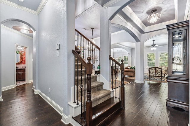 245 Prairie Oak Ct, Burleson, TX 76028 - entrance foyer with arched walkways, dark wood finished floors, ornamental molding, ceiling fan, and baseboards