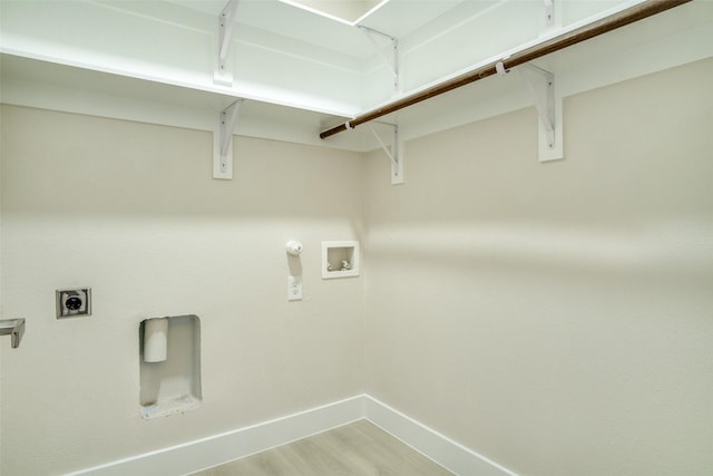 washroom with laundry area, washer hookup, light wood-style flooring, baseboards, and electric dryer hookup