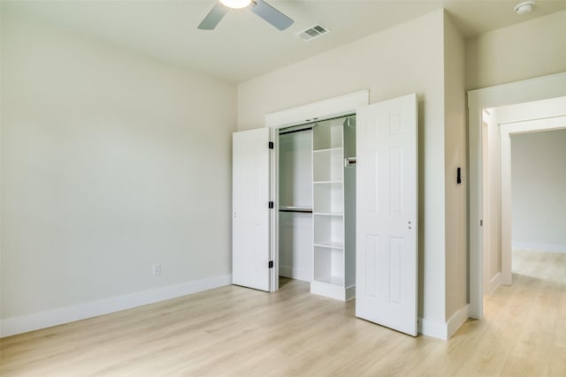 unfurnished bedroom featuring baseboards, visible vents, light wood-style flooring, and a closet