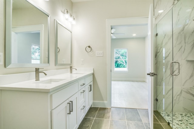 bathroom featuring a sink, a marble finish shower, ceiling fan, and tile patterned floors